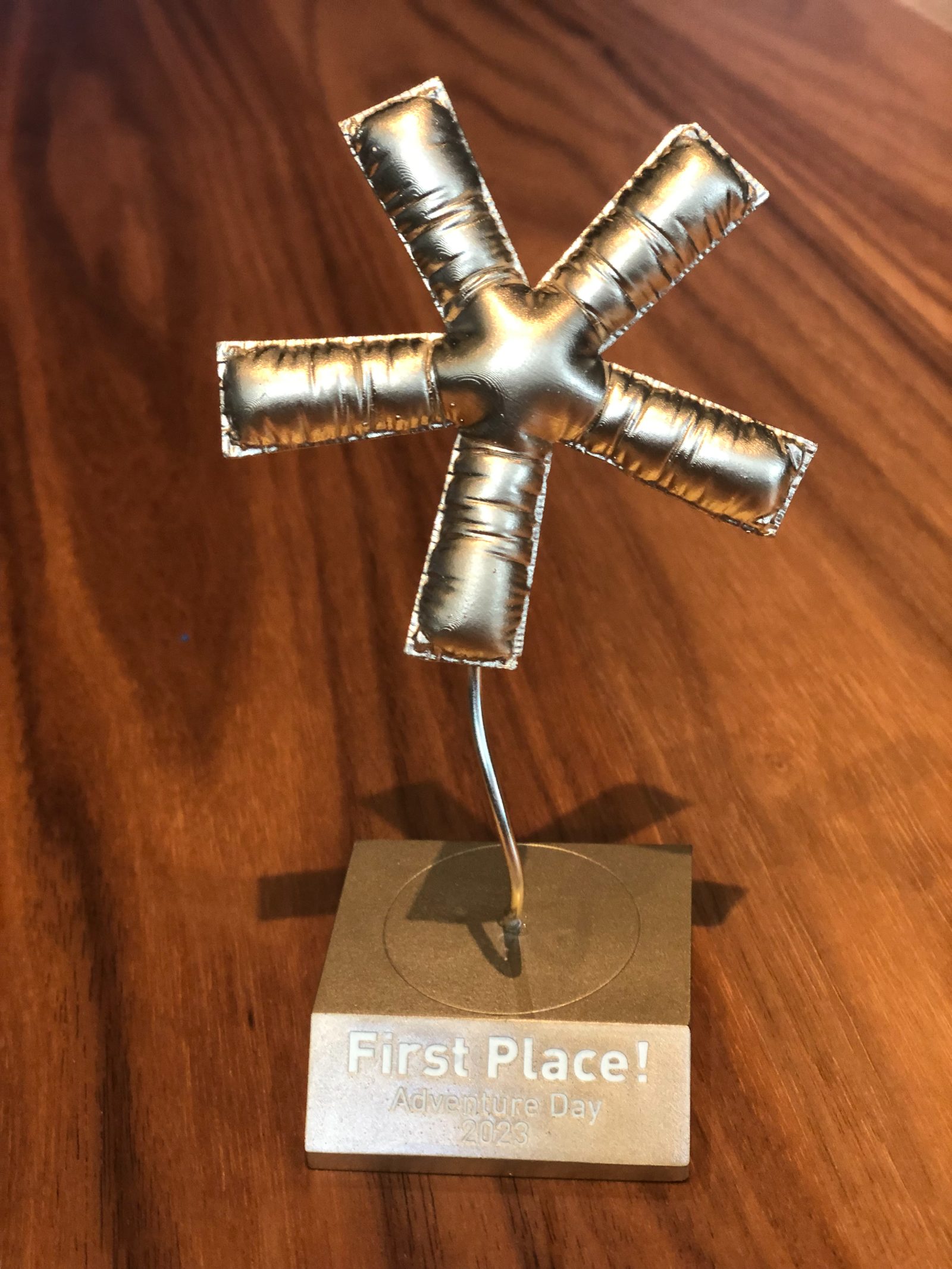 A hand-made asterisk trophy engraved First Place