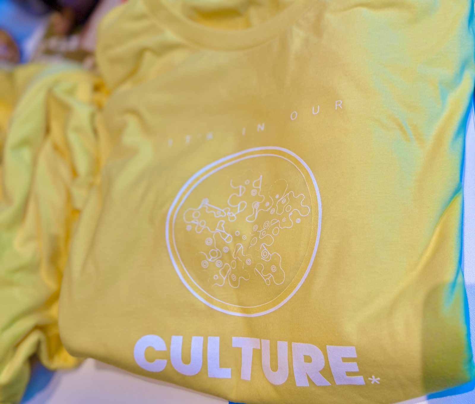A yellow studio shirt printed with the word Culture