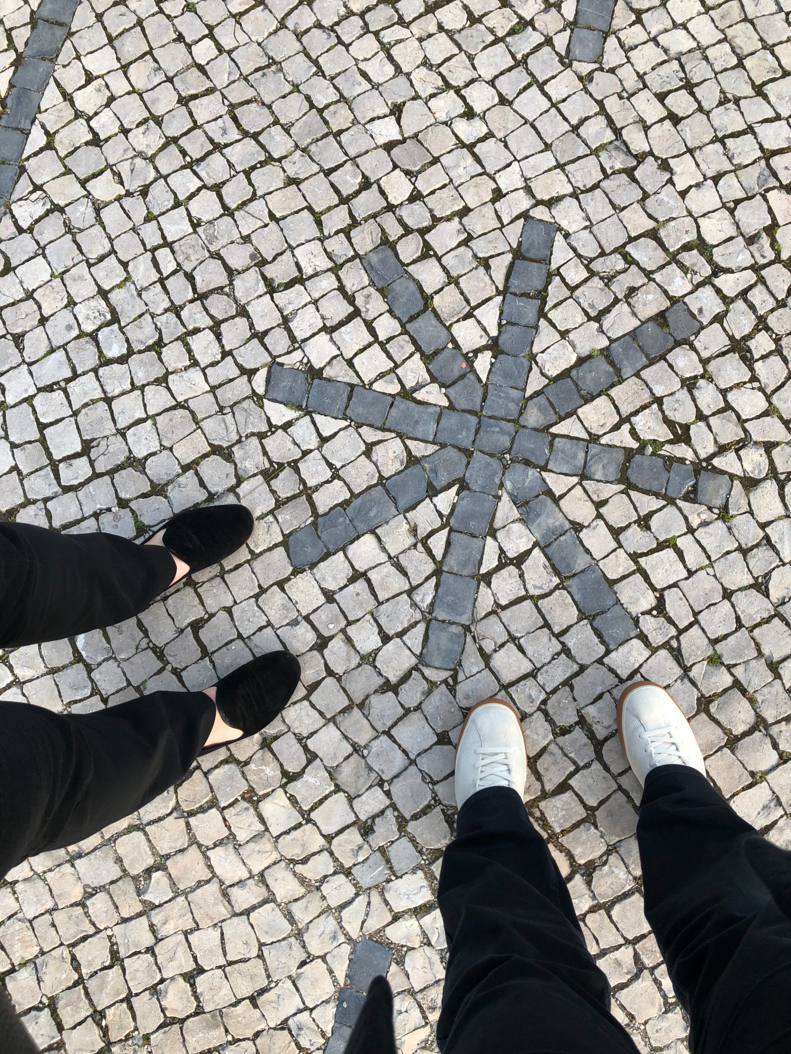 An asterisk motif set into a cobblestone pavement