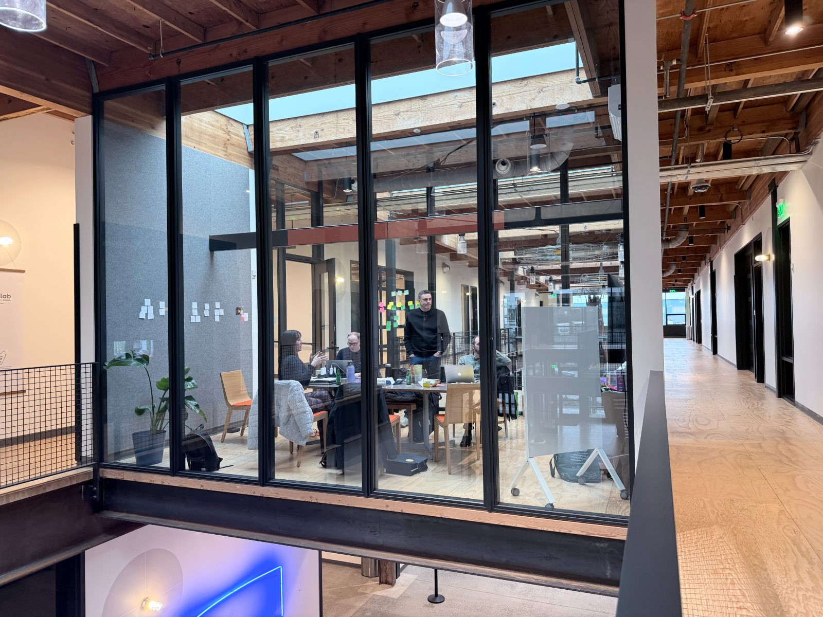 A leadership offsite working session seen from the mezzanine