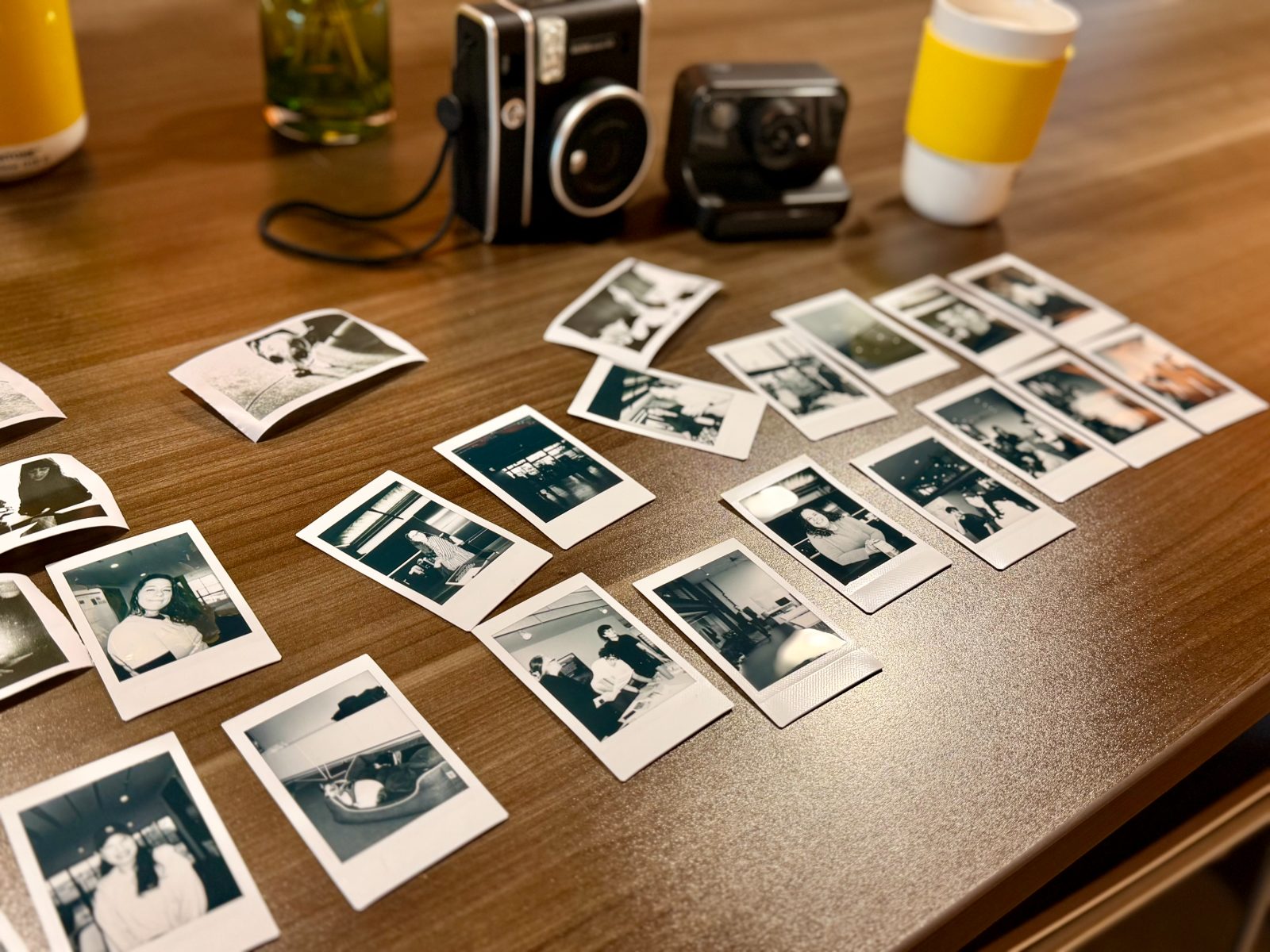 Instant photographs from the retreat spread across a table
