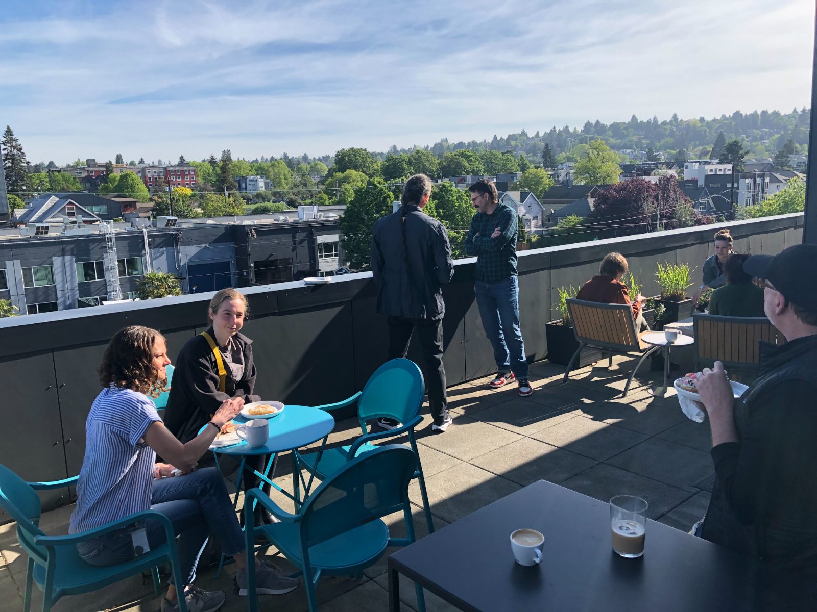 Colleagues talking on a rooftop during the corporate retreat