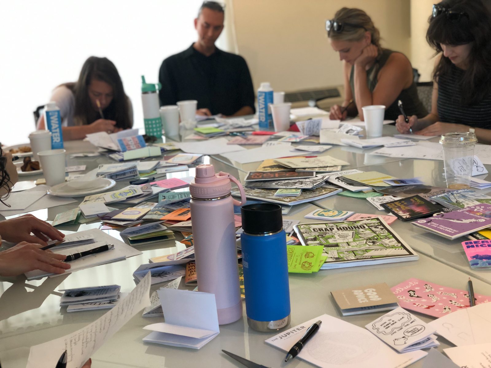 A work table covered in materials during a retreat session