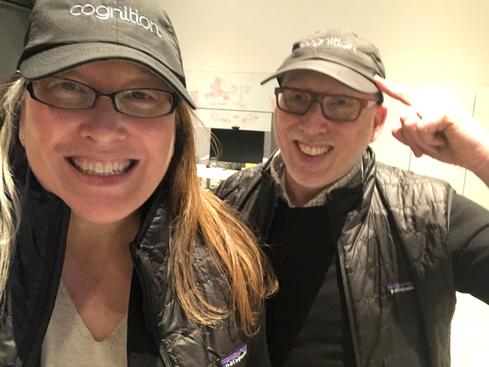 Two colleagues in studio caps during spirit week